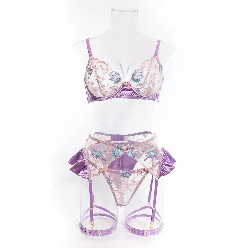 Light purple satin lingerie four-piece set with embroidery detailing on hanger