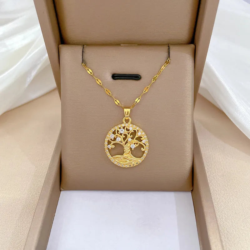 Gold-plated necklace with rhinestone tree pendant featuring mother-of-pearl detail on adjustable lip chain