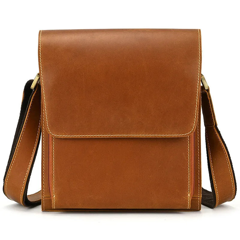 Men's brown cowhide leather crossbody bag with flip shoulder strap and retro style.