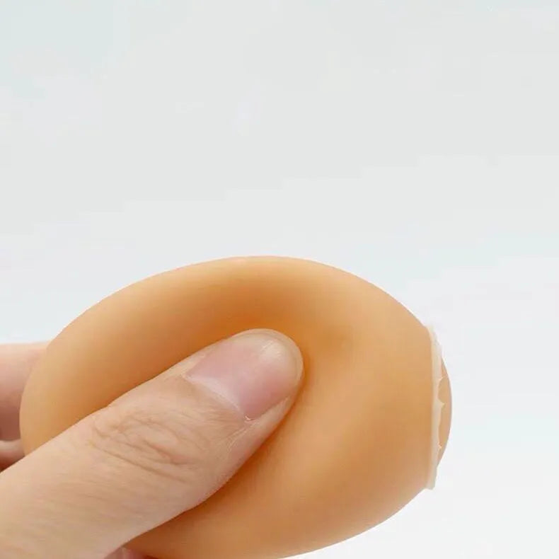 Yellow egg-shaped dog teeth cleaning toy with textured rubber surface for dental care