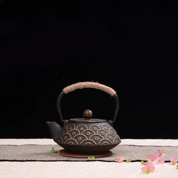 Cast iron teapot with traditional Japanese design and 0.9L capacity for tea brewing