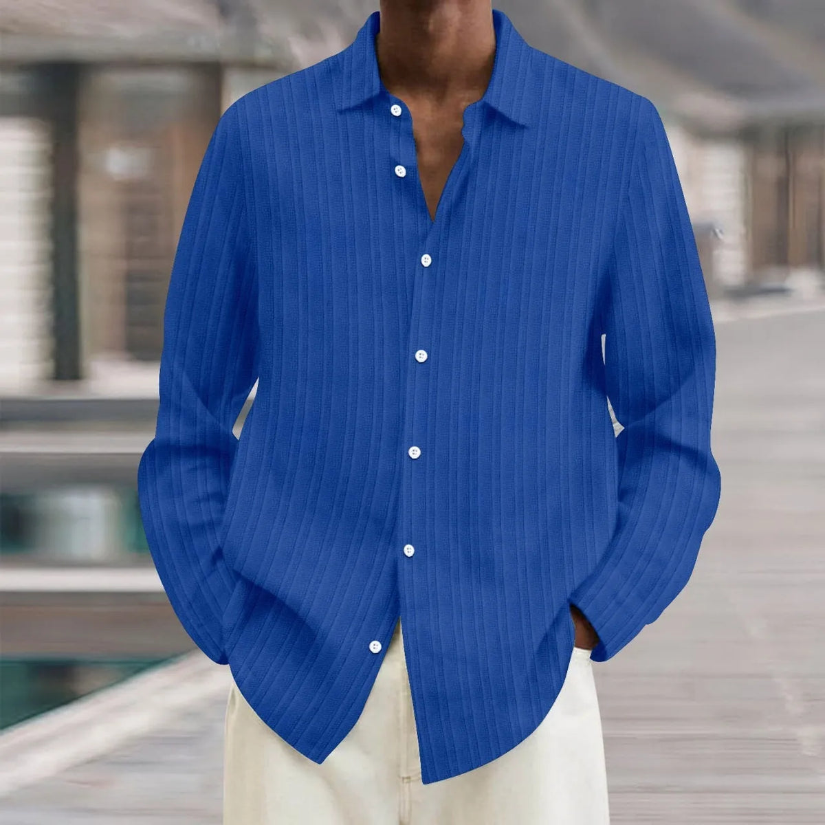 Man wearing a British-style striped cardigan with long sleeves and a loose fit