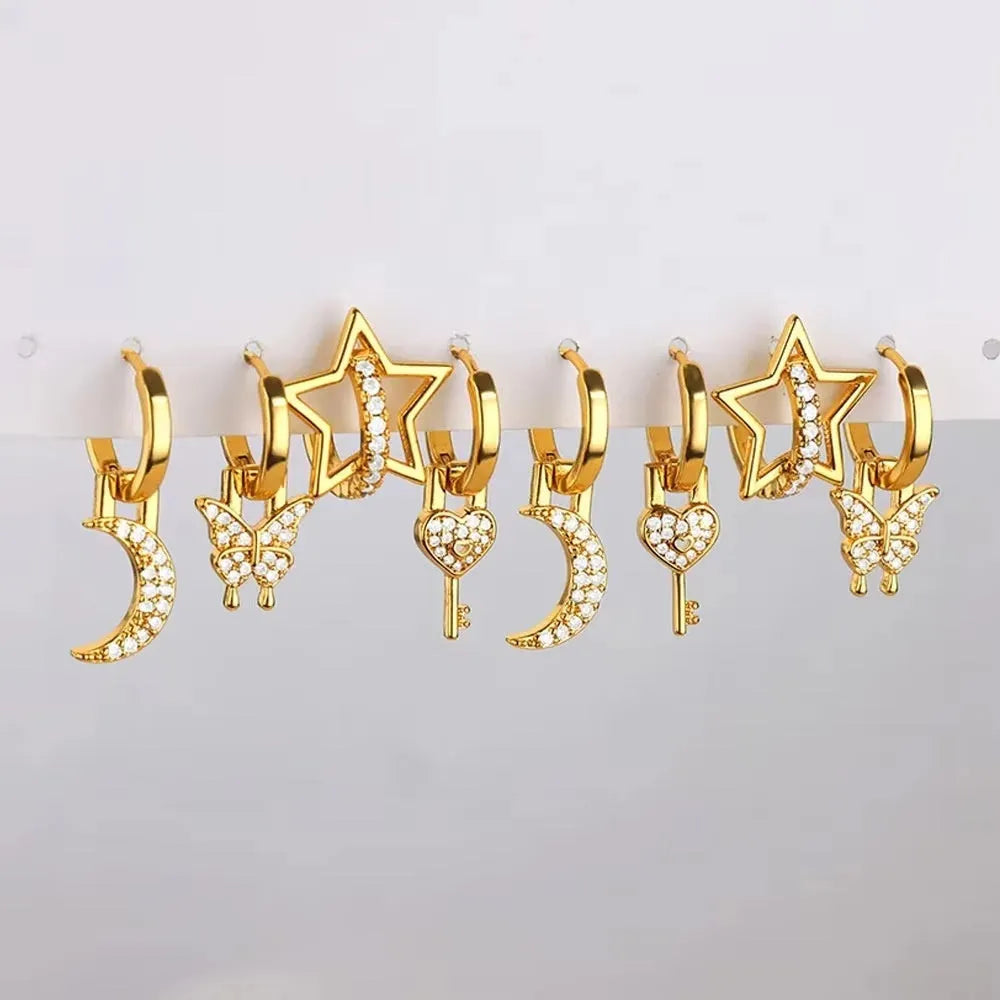 A pair of women's geometric butterfly-shaped earrings made from copper with heart and star details.