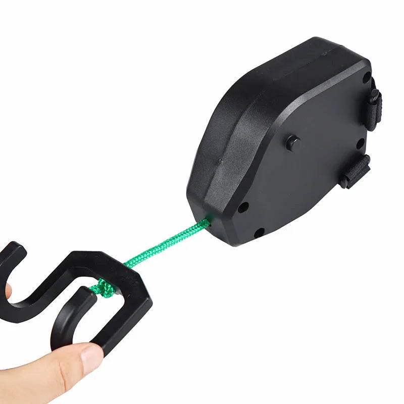 Black plastic bicycle trailer rope connecting mountain bike to child trailer