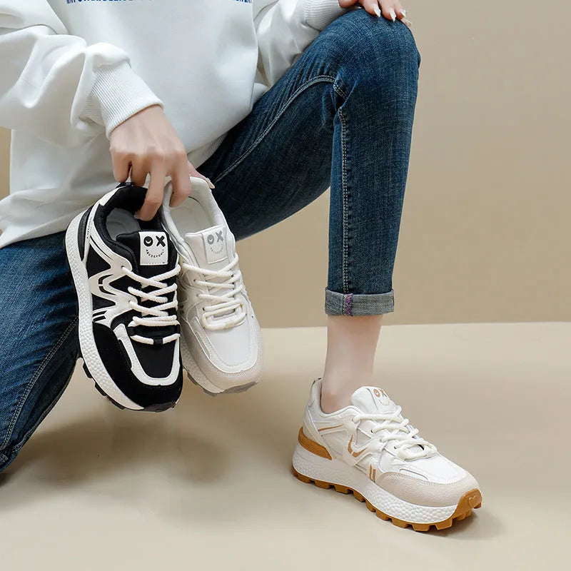 Women's black platform casual sports shoes with flat heel and white lace-up front closure on a neutral background.