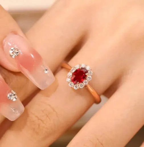 Women's silver-plated floral ring with a gold pigeon red blood gemstone centrepiece.