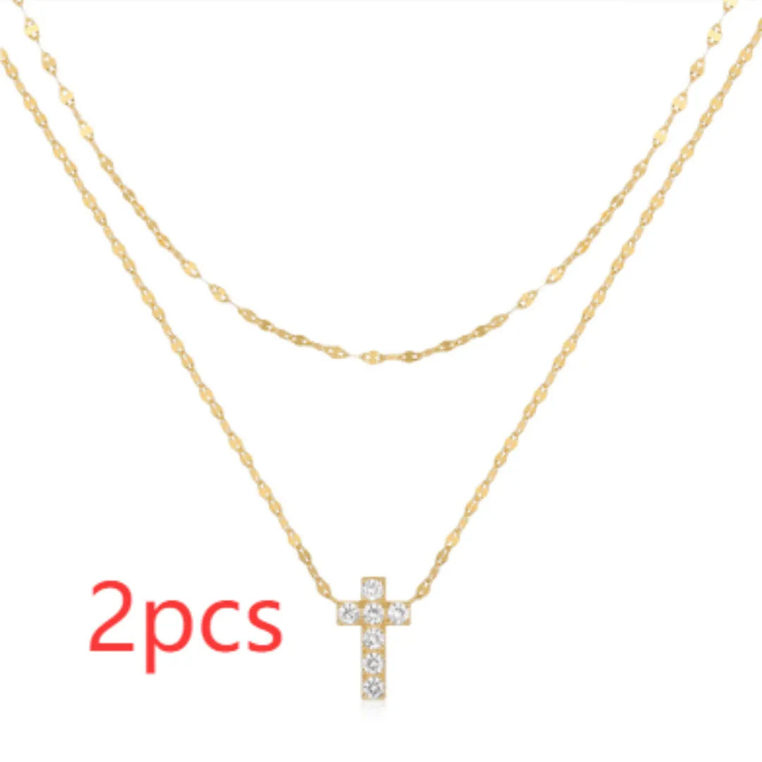 Close-up of a sterling silver double-layer geometric cross pendant on a clavicle chain.