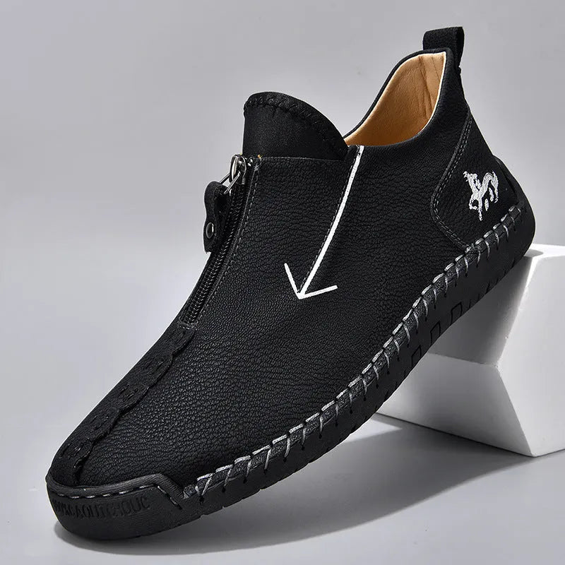 Men's black casual Martin boots with a front zip, round toe, and low rubber sole.