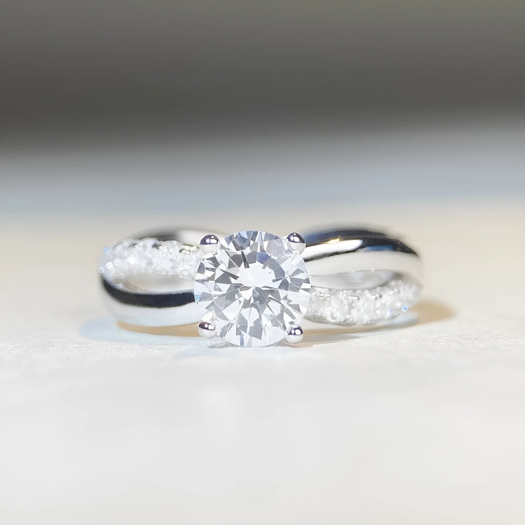 Silver twisted arm ring with a 1 karat moissanite stone in a four-claw setting.