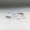 Silver twisted arm ring with a 1 karat moissanite stone in a four-claw setting.