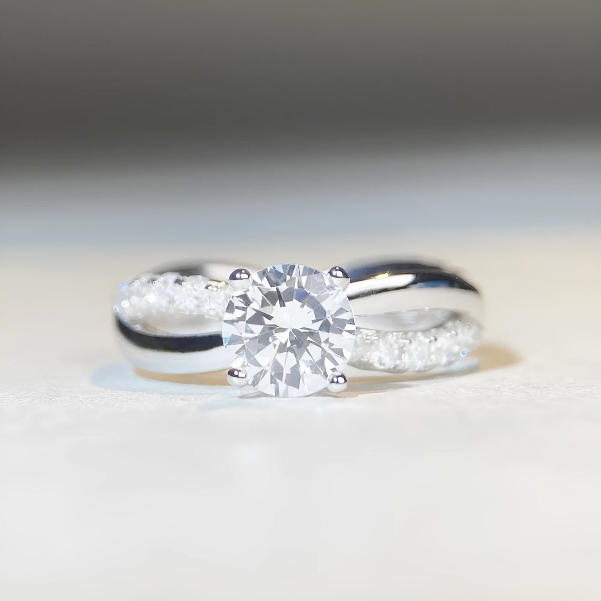 Silver twisted arm ring with a 1 karat moissanite stone in a four-claw setting.