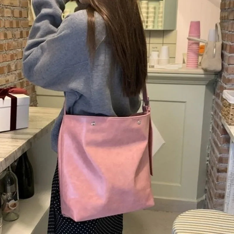 Pink corduroy one-shoulder crossbody bag showing front view and size.