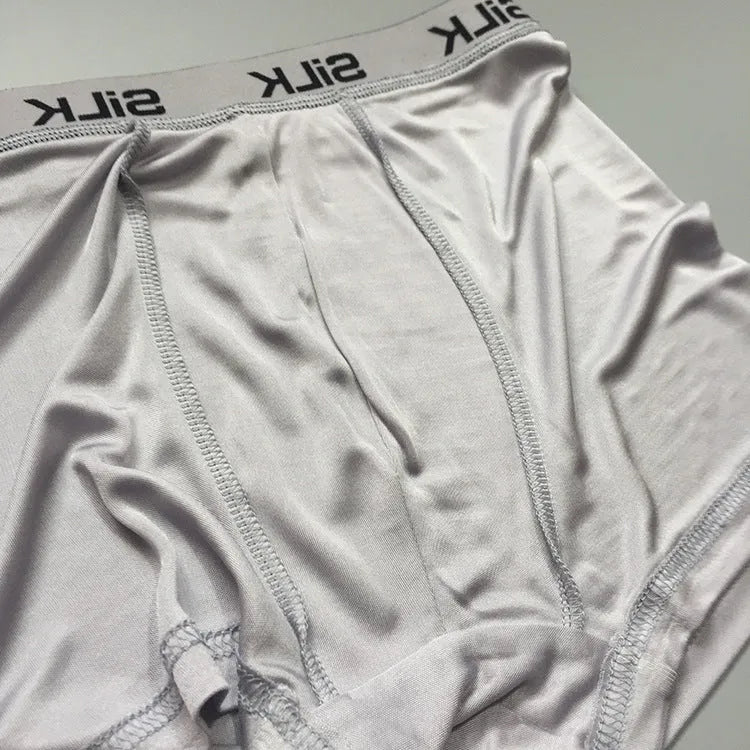 Men's loose silk shorts in navy blue, silver gray, and skin color with mid-waist design