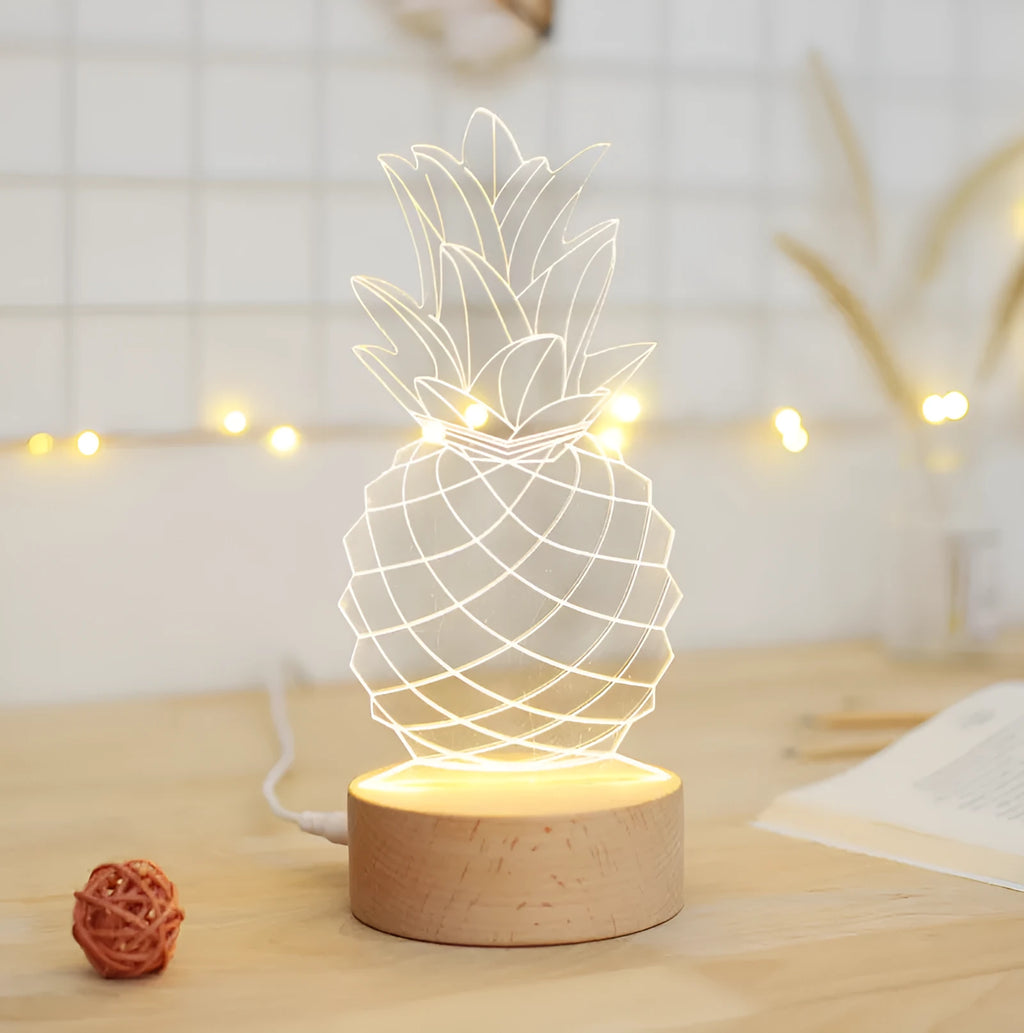 Wood and acrylic pineapple-shaped cartoon night light with USB cable and dimmer switch on a table.