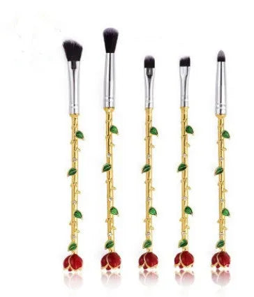 Beauty and the Beast makeup brushes with character-themed bristles and golden or silvery handles