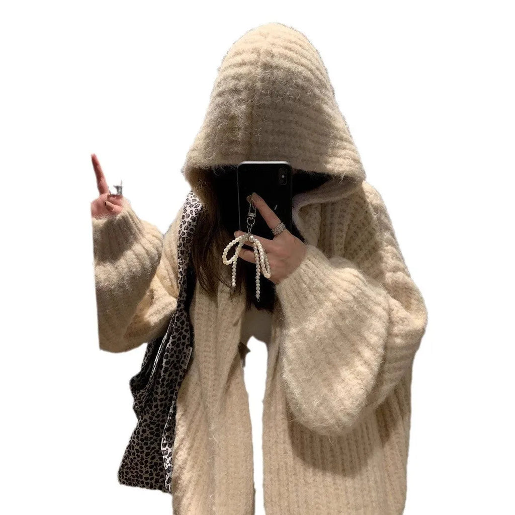 A woman wearing a thick, dark gray retro-style hooded cardigan with regular sleeves.