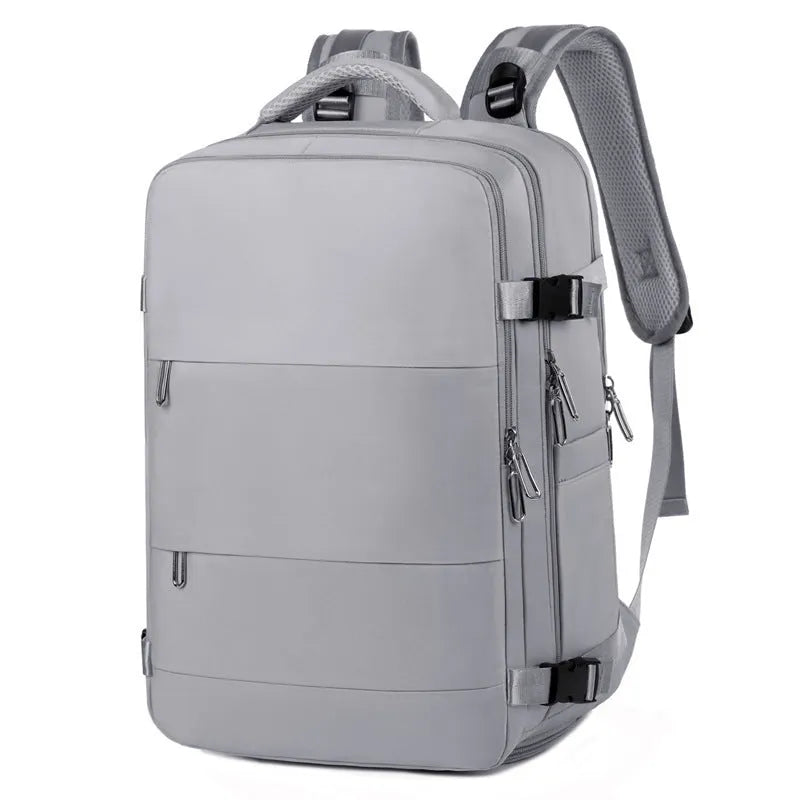 Large purple travel backpack with multiple compartments, shown next to a laptop.