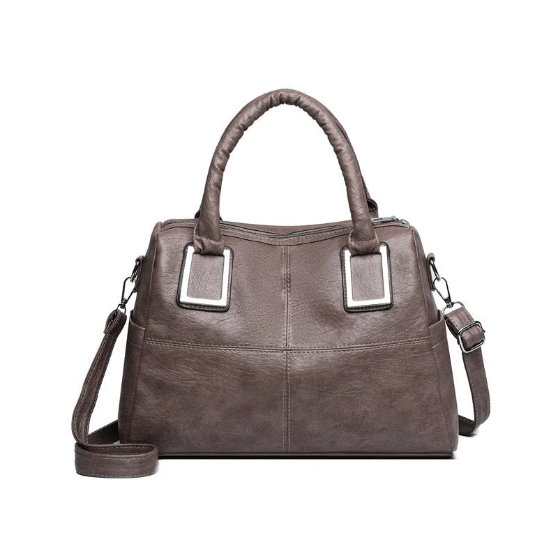 Women's large capacity shoulder bag in horizontal square shape with internal phone and document pockets.