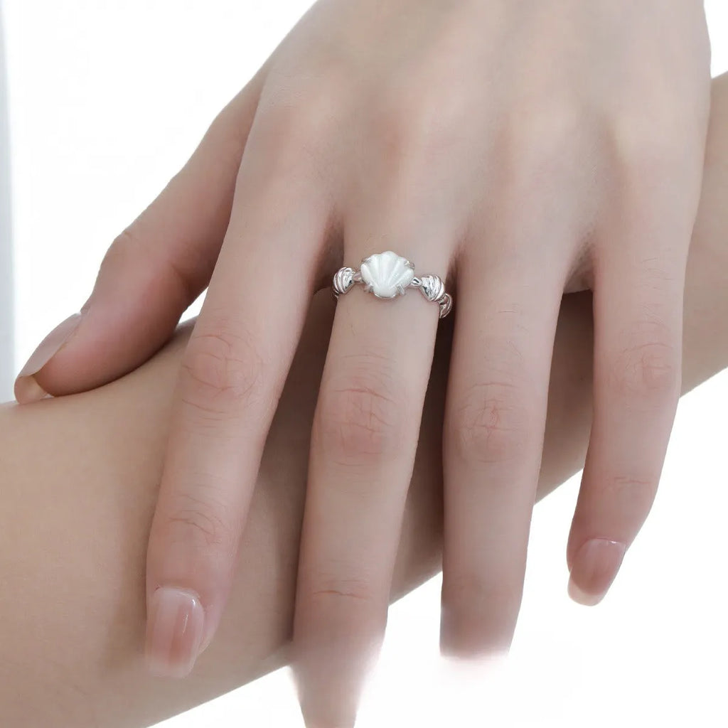 Adjustable silver ring with a white shell and tiger eye design in a choice of gold or white gold finish.