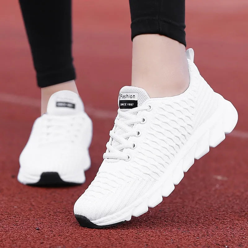 Women's running shoes in black, pink, or white with a fly weaving upper and rubber outsole.