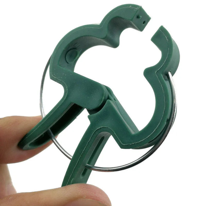 Green plastic plant fixing clips for supporting climbing vegetables and garden vines