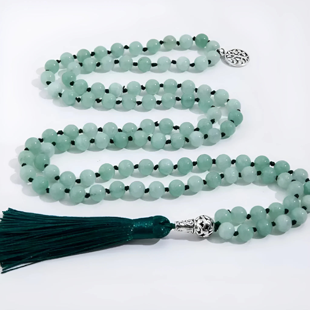 Handmade knotted beaded necklace with geometric stone pendant in natural colours.