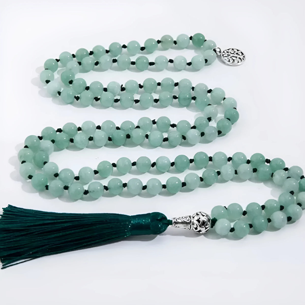 Handmade knotted beaded necklace with geometric stone pendant in natural colours.
