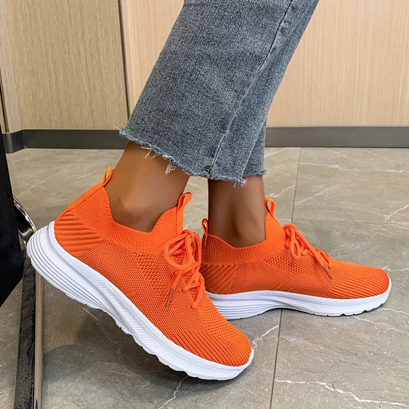 Women's creamy white mesh running shoes with flyknit upper and flat rubber sole