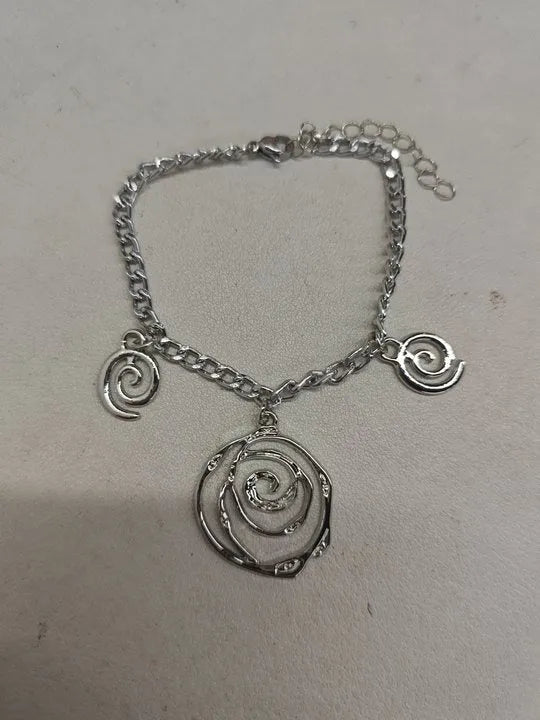 Spiral donut jewellery set with geometric circle designs including adjustable necklace, bracelet and ear hooks