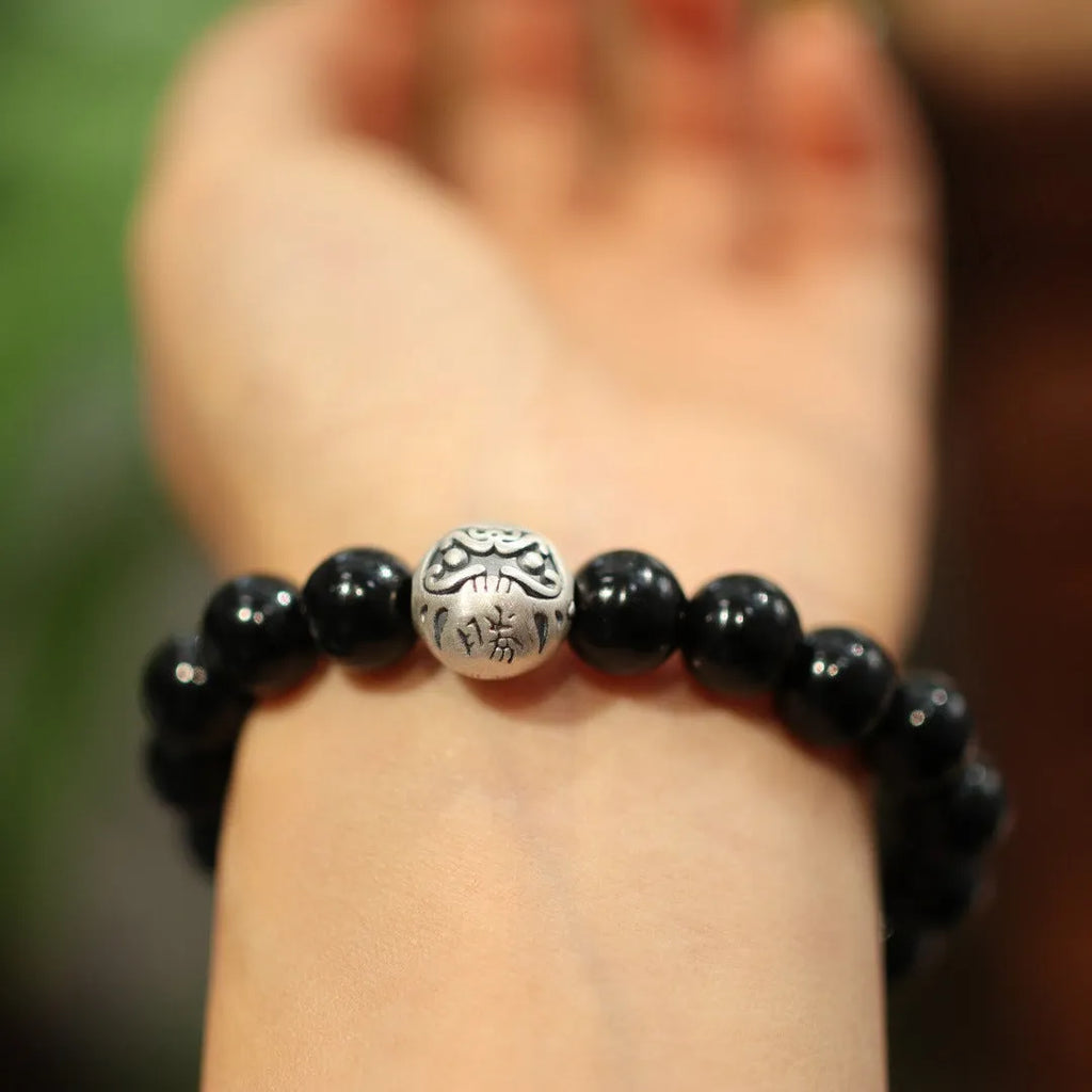 Black agate bead bracelet with sterling silver fastening on wrist