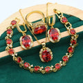 Olive green zircon jewellery set with snake bones chain necklace, matching earrings, and ring on a copper base.