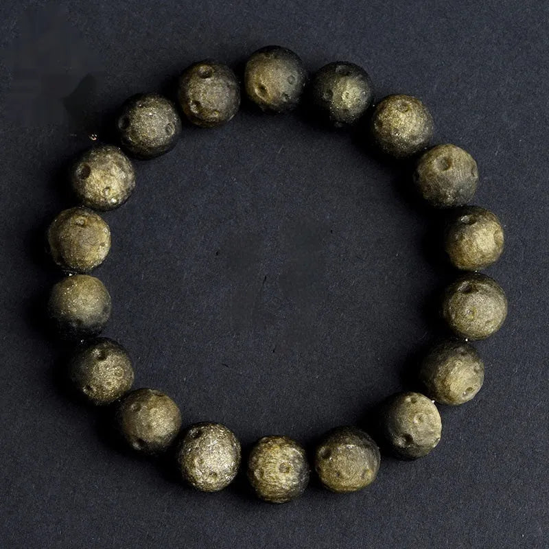 Obsidian ball bracelet with natural crater texture in silver stone meteorite colour with grinding finish