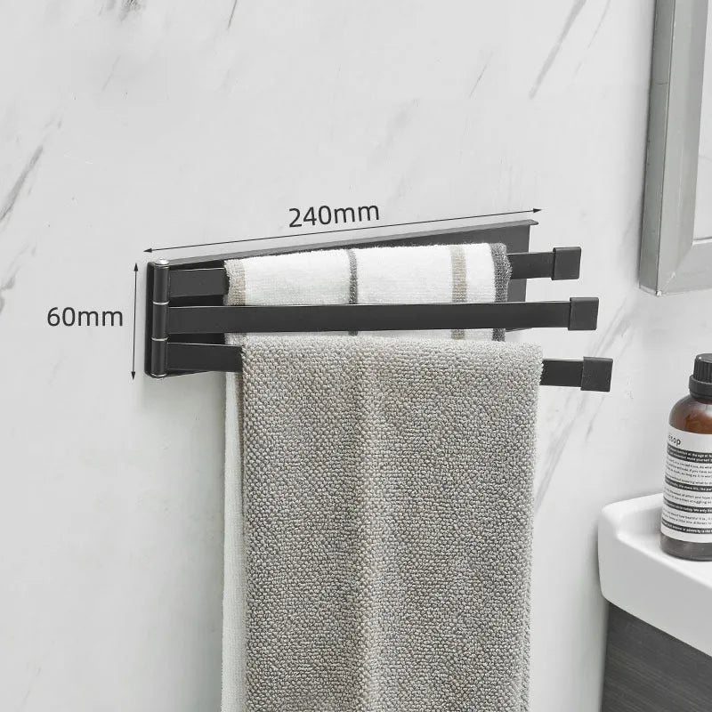 Black folding towel rack mounted on bathroom wall with towel hanging