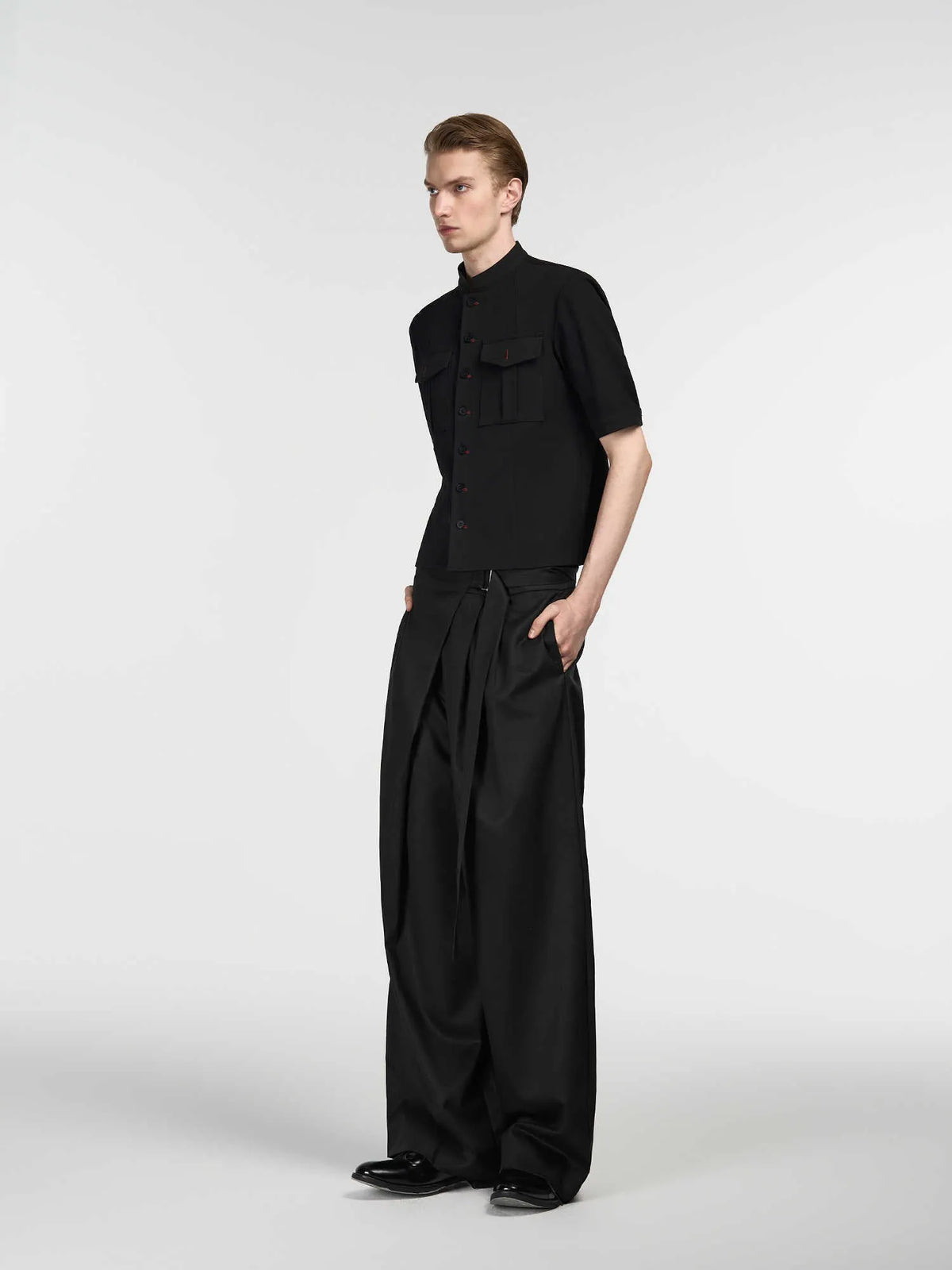 Black straight-leg trousers with an adjustable waistband and a single pleat detail.