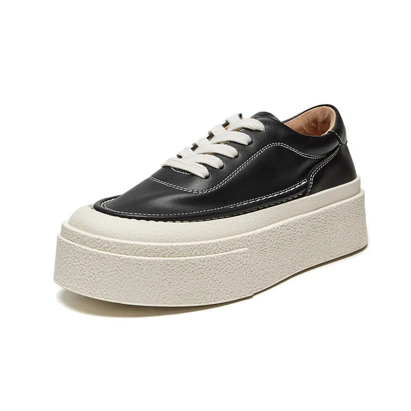 Women's black embossed leather platform sports shoes with a round toe and rubber sole.