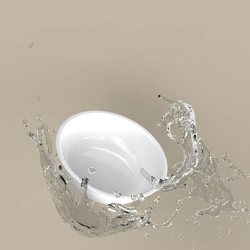 Green tilted stainless steel cat bowl with 15 degree angle on white PP plastic base