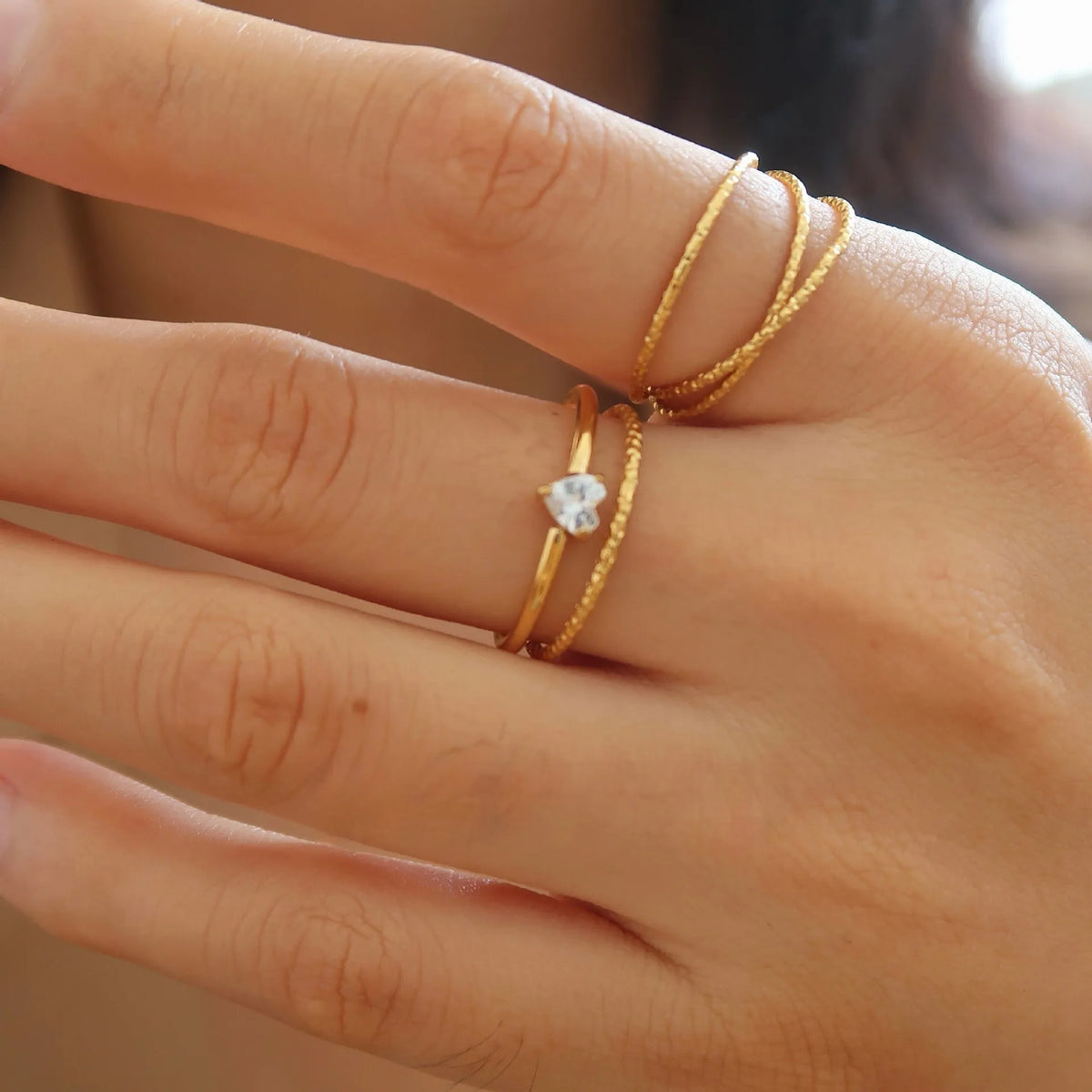 Stainless steel heart shape ring with a golden electroplated finish, shown in Heart and Oval colour variations.