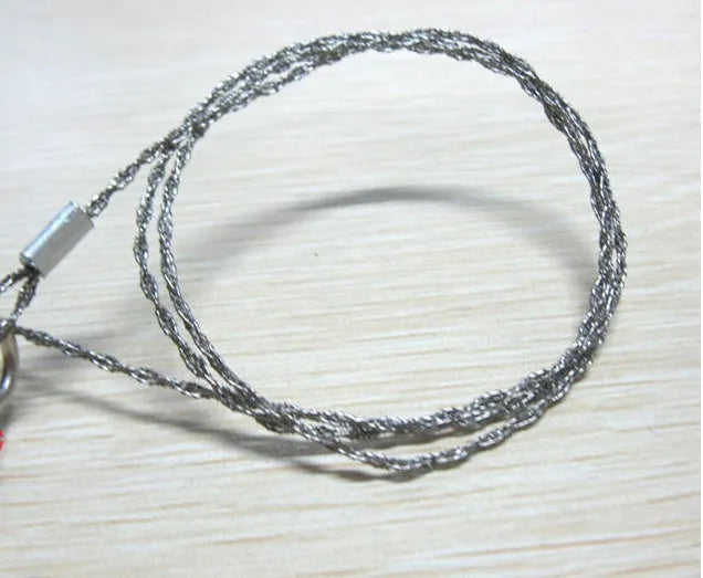 Survival wire saw with thumb rings extended to 70cm total length on a background.