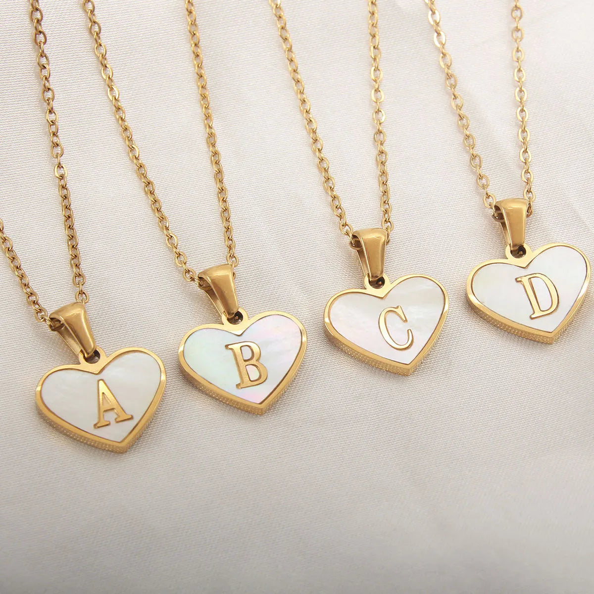 Gold-plated heart-shaped white shell necklace with adjustable chain and letter personalisation option