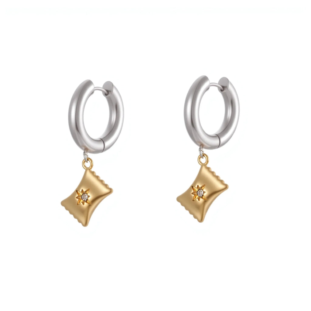 A pair of gold-coloured stainless steel earrings featuring a Christmas tree design and a heart shape with star details.