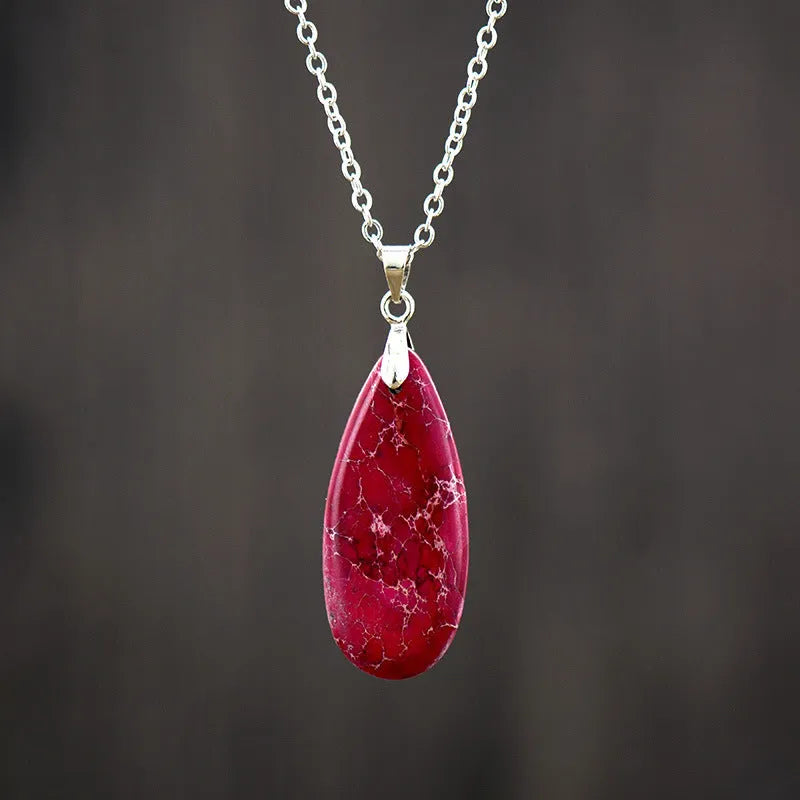 Water drop shaped emperor stone jade pendant on an 18K gold plated chain necklace.