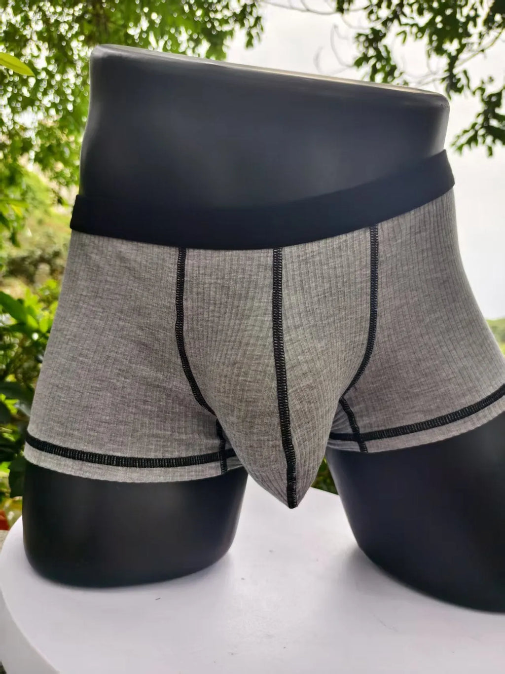 Men's solid colour boxers in Army Green shown flat, highlighting thin breathable fabric and body shaping design.
