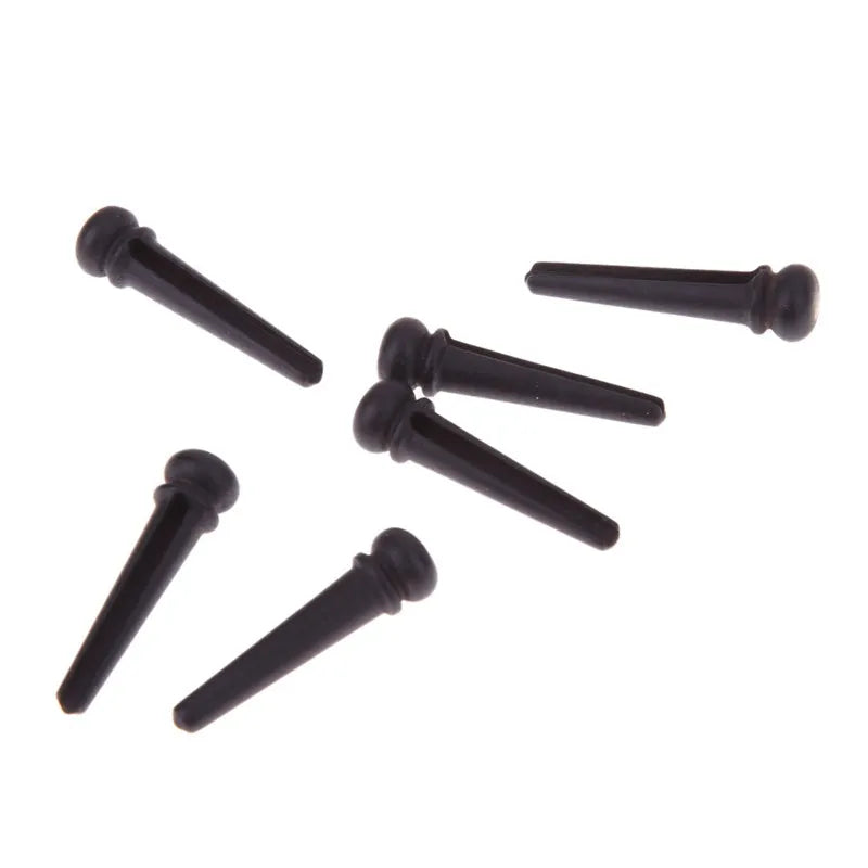 Six matt black ebony guitar string nails with a 5.3mm bayonet diameter for folk acoustic guitars.
