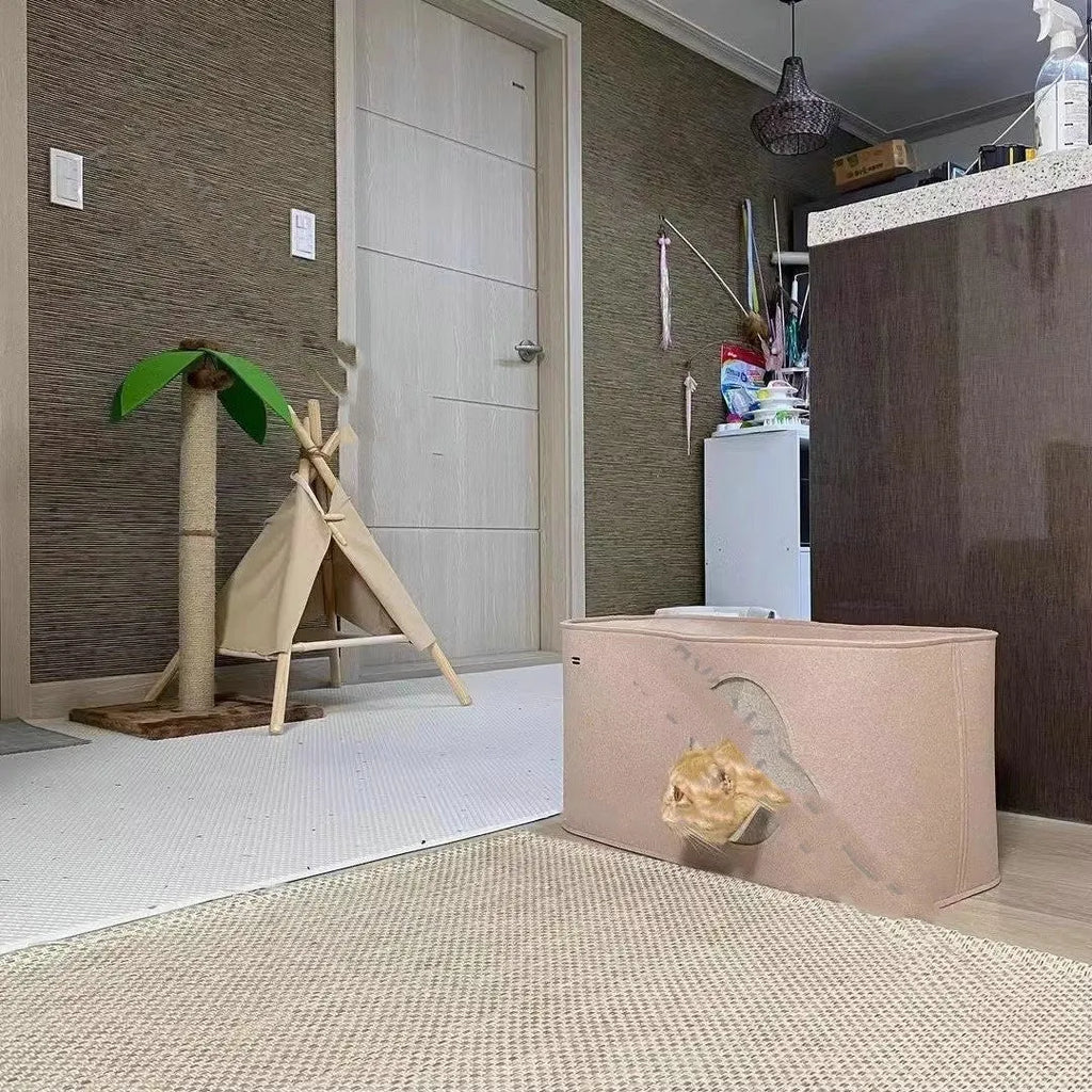 Foldable grey felt cat nest bed shown in a home setting, with a cat resting inside.