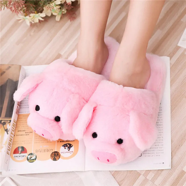 Pink plush pig-themed floor slippers on a white background.