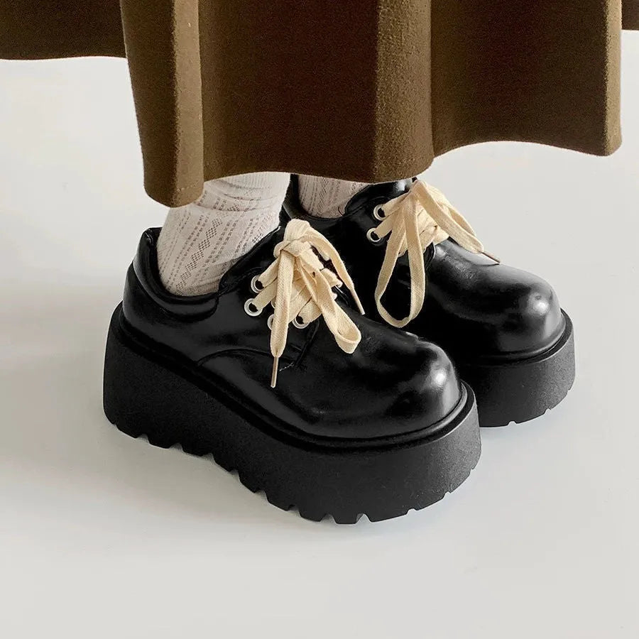 Matte black women's lace-up buckle boots with a thick sole and 6-8cm chunky heel on a white background.