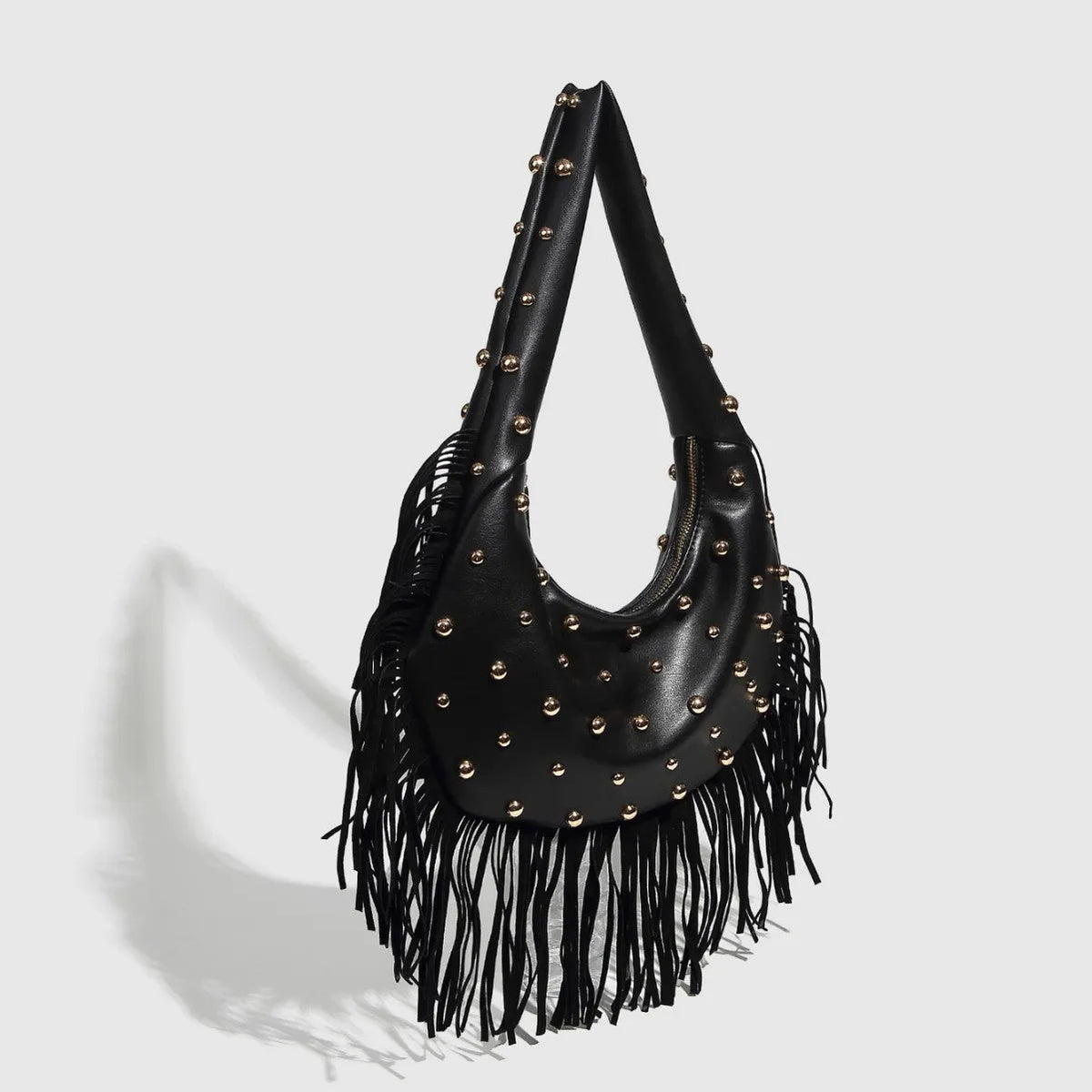 Retro black shoulder handbag with tassel detail showing interior mobile phone compartment and polyester lining