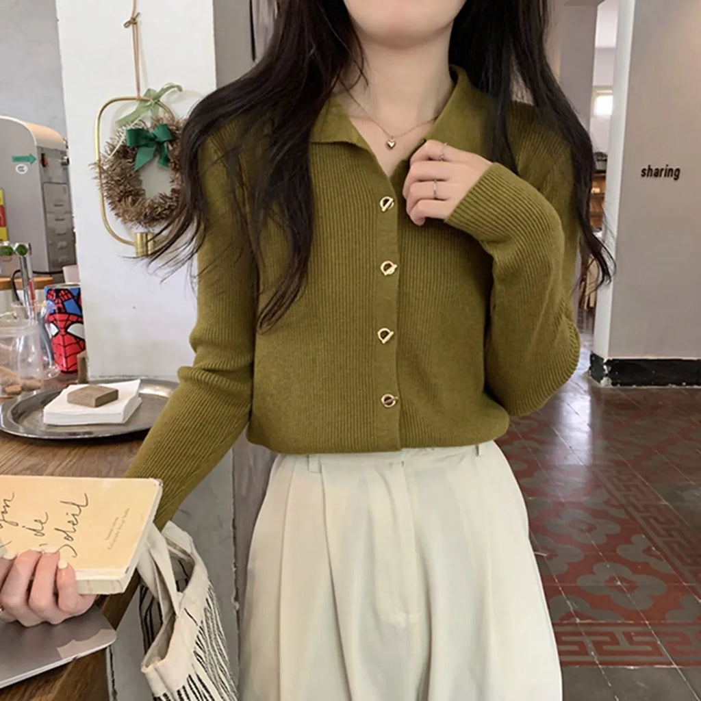 Beige long-sleeved viscose knitted cardigan hanging on a hanger, loose fit