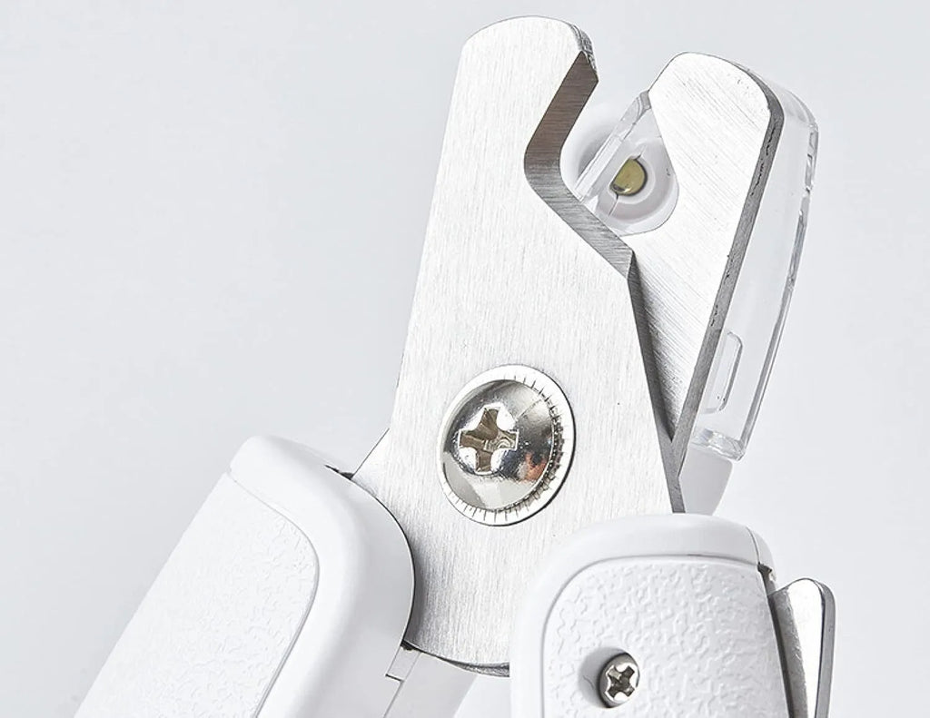 White LED pet nail clippers with transparent anti-splash guard open to show triangular stainless steel blades