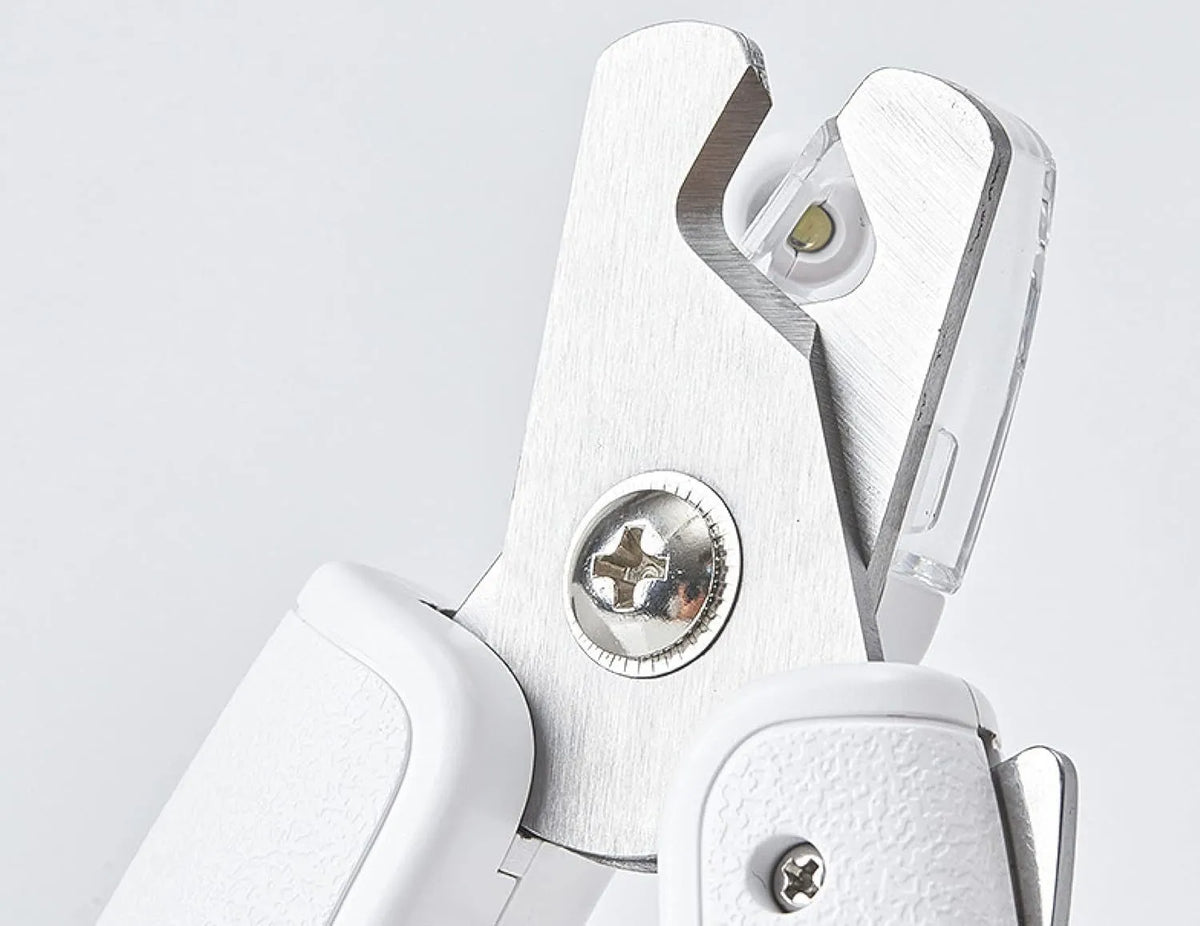 White LED pet nail clippers with transparent anti-splash guard open to show triangular stainless steel blades